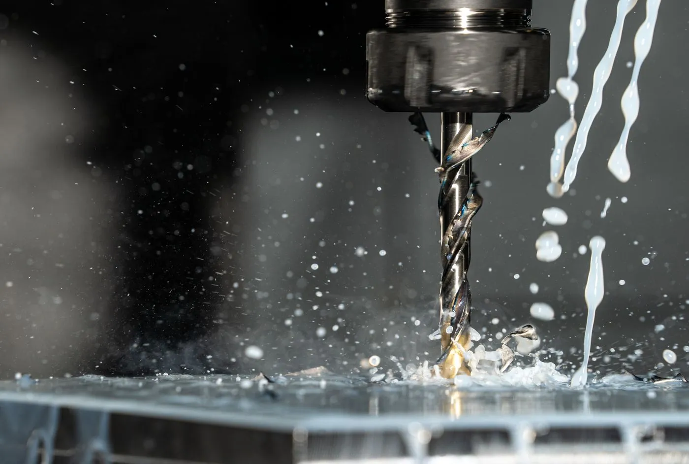 Coolant flooding a metal part on a CNC machine